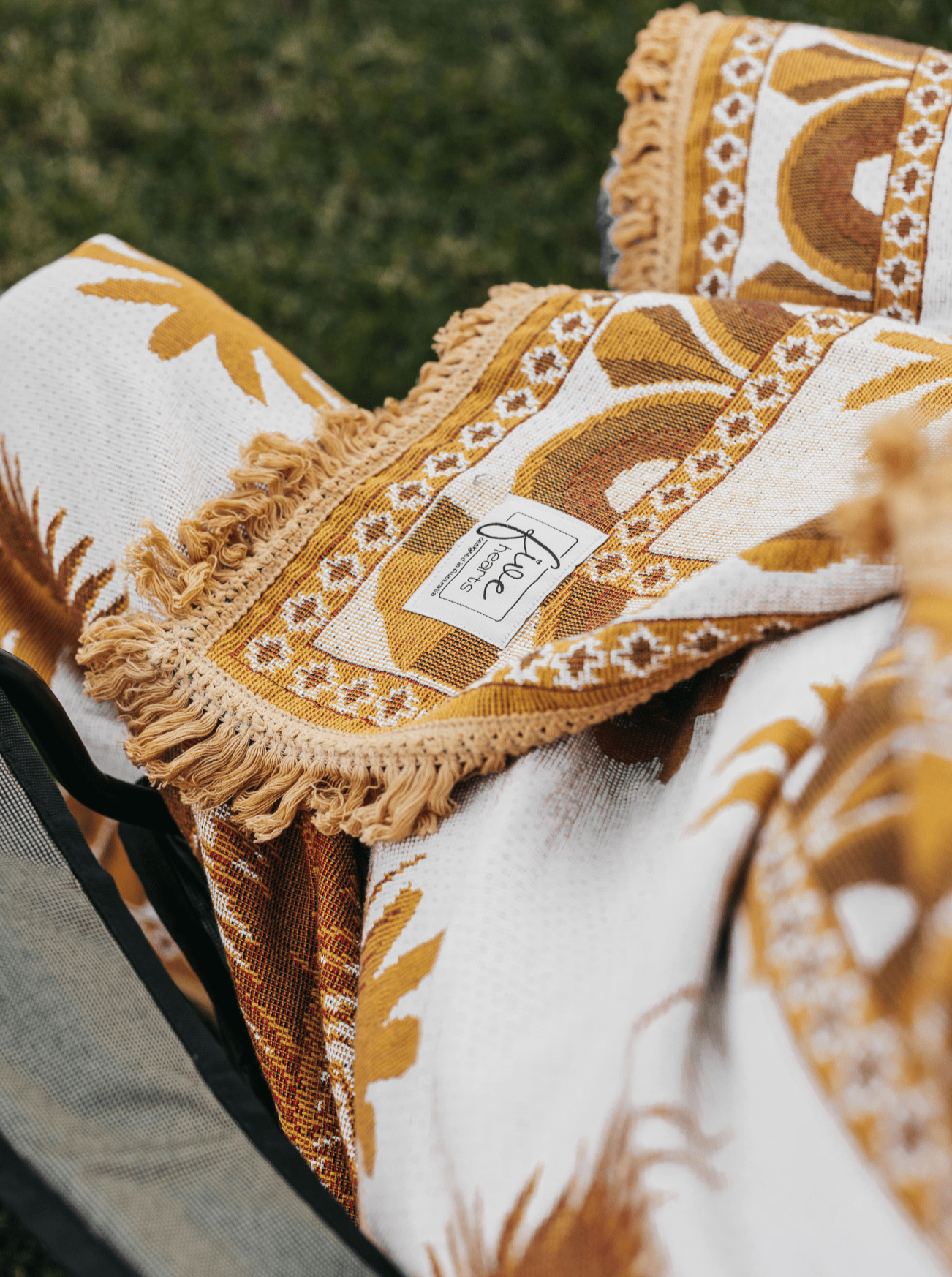 Close up of Endless Summer throw blanket on camping chair