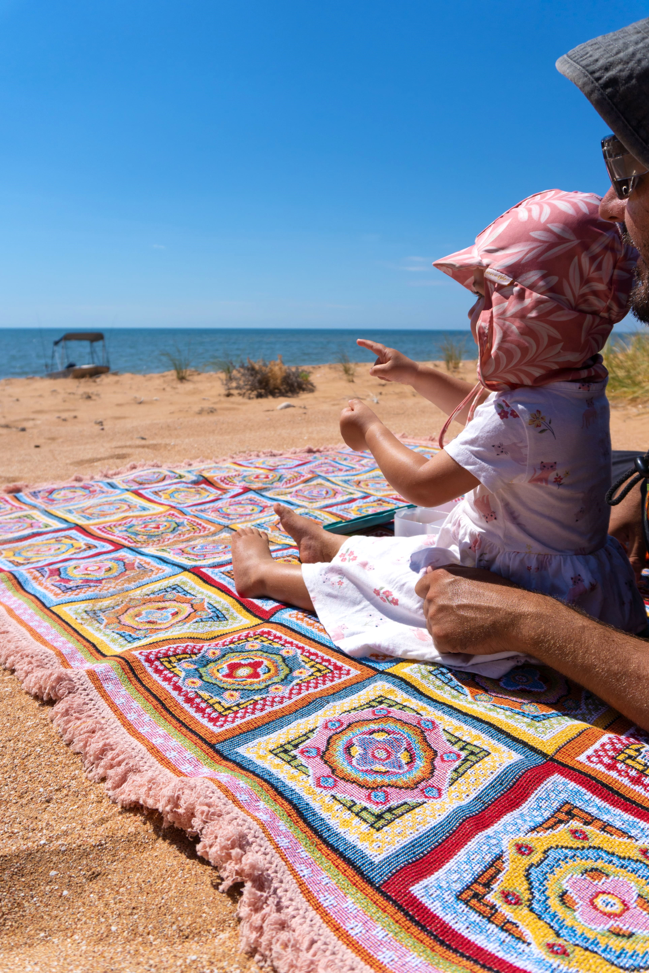 Forever Young Beach Blanket laid on the sand with a father and daughter making memories.