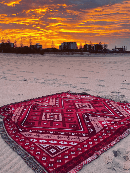 Red beach blanket / throw rug on Gold Coast beach watching sunset skies